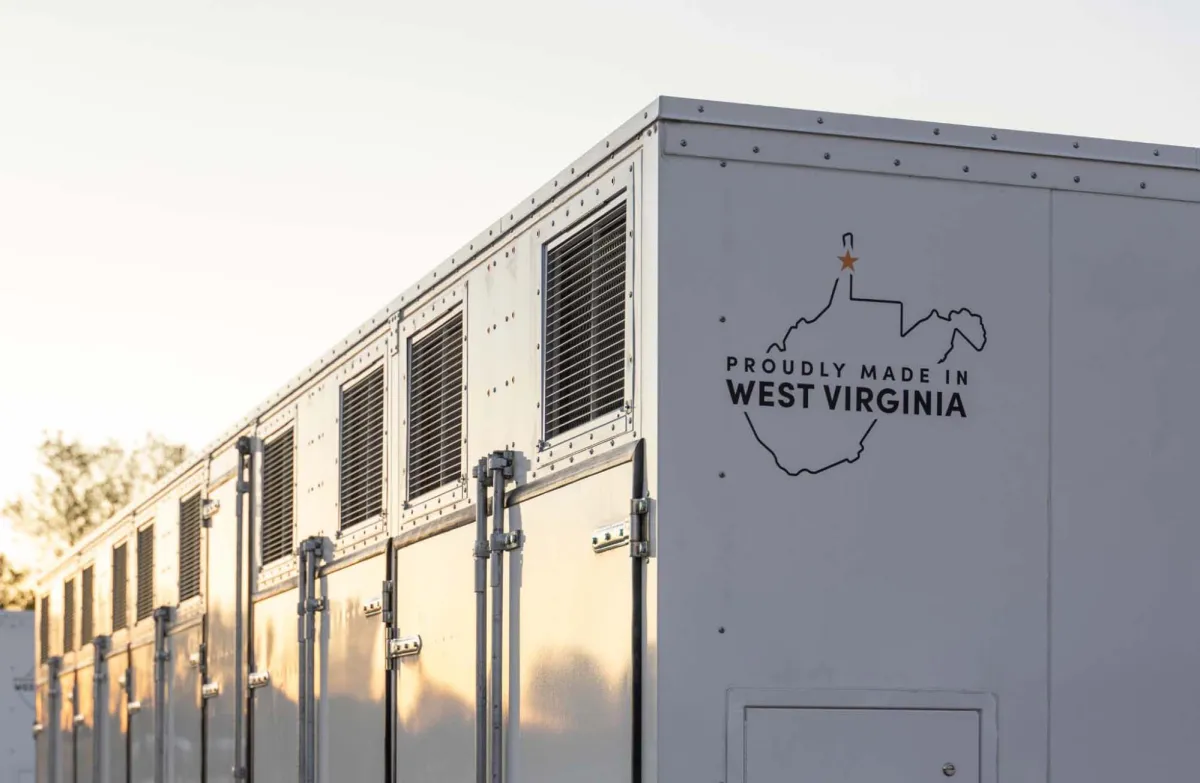 A grid-scale battery stands against a clear sky.