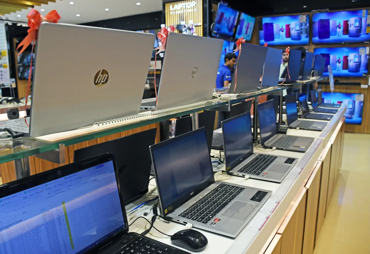 Laptops of different brands are kept on display at Vijay Sales electronic store.
