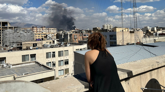 an eerie quiet is punctuated by explosions and people fleeing